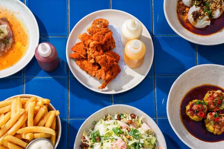 Close-up of fried chicken with kimchi spice and mango-pineapple hot sauce.